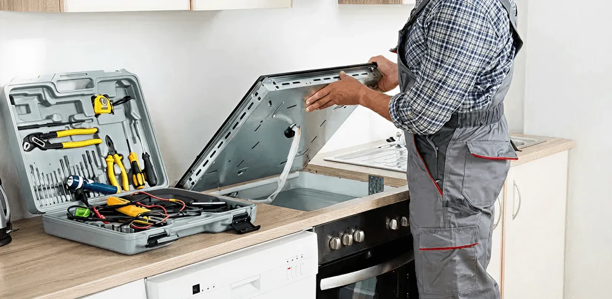 Handyman repairing a cooktop and checking wiring connections in Allentown, PA