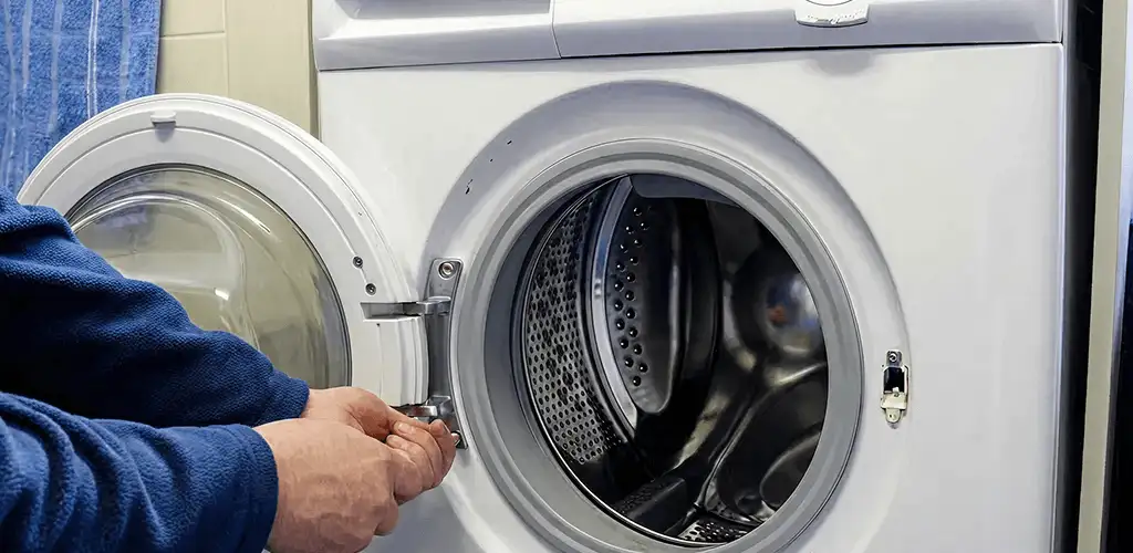 Washing machine repair handyman checking a front-load washer door and latch in Allentown, PA