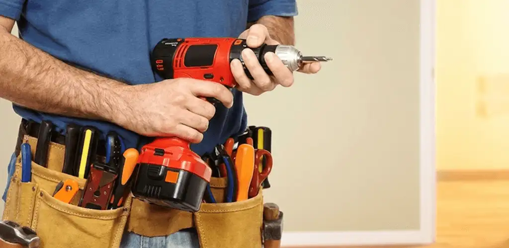 Handyman holding a power drill for home repairs and installations in Allentown, PA