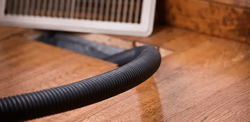 Air duct cleaning hose inserted into a floor vent for ductwork cleaning in Allentown, PA