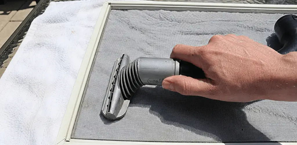Window screen repair cleaning and fixing a damaged screen mesh in Allentown, PA